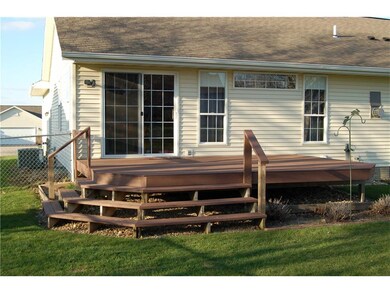 Nice deck welcomes you to a large back yard.