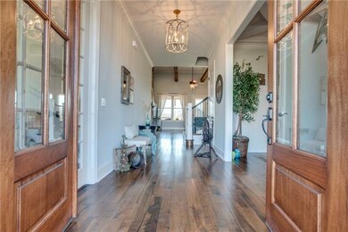The entry is truly Breathtaking!!  The Wormy Maple Hdwds throughout the downstairs are gorgeous! The entire downstairs has 10 ft ceilings and 8 ft doors.