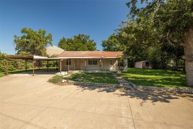 View of front facade featuring a front yard, a car