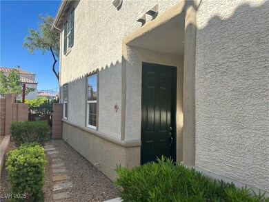 Doorway to property with stucco siding and fence