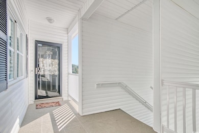 Entry door of end unit condo with building stairs