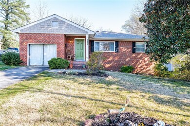 Single story home with a front lawn and a garage