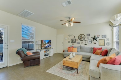Living room with light tile patterned floors and a ceiling fan