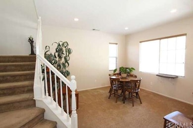 The cozy living room is directly to your right as 
