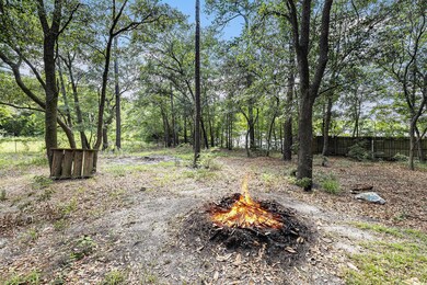 View of yard with an outdoor fire pit