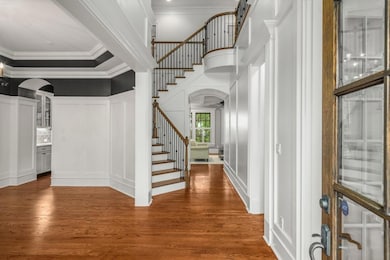 Open double height entry foyer; dining to left; of