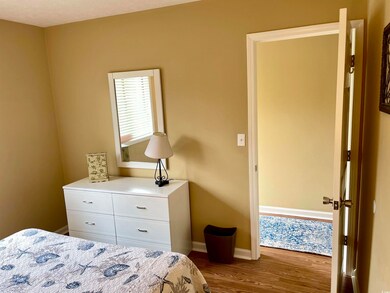 Bedroom featuring dark wood-type flooring