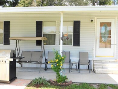 Covered patio in front of home.