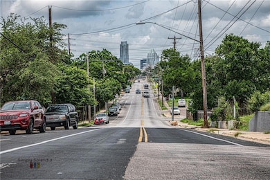 View of asphalt street with street lights, sidewa