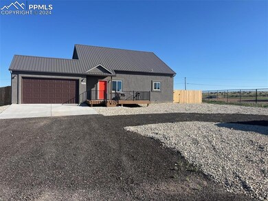 View of front facade with a garage and a deck