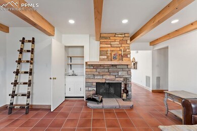 Wood-burning fireplace with stone hearth and mantle