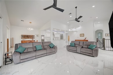 Living room with ceiling fan, marble finish floors