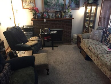 Living room has a mock fireplace