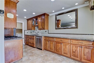 Fully remodeled kitchen with high end cabinets, beautiful granite counters extended to give extra counter space and cabinets. Tile backsplash, recessed lighting, 5-burner stove, b/I microwave.
