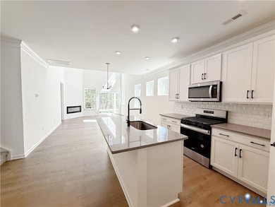 Stepping inside, you’ll travel through the inviting foyer to the kitchen which features a center island, quartz countertops, gas cooking, and a walk-in pantry. 
