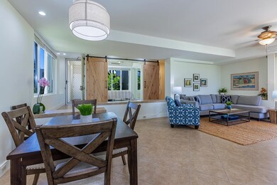room, dining area, & kitchen, with views of lush landscaping in every direction.