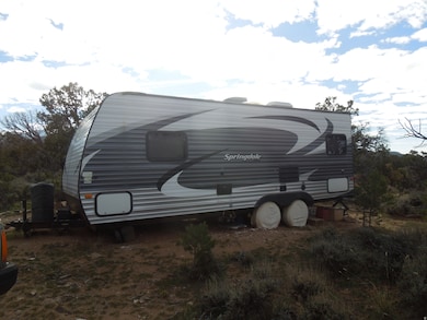View of side of home featuring a gambrel roof