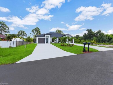 Modern home featuring concrete driveway and an attached garage