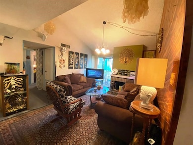 This cozy living room features vaulted ceilings, w