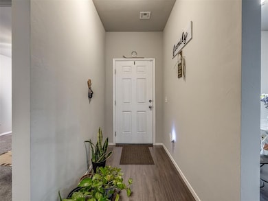 Entryway featuring wood finished floors and baseboards