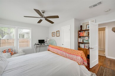 Bedroom with dark wood finished floors, ceiling f