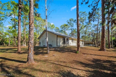 View of side of home featuring a lawn