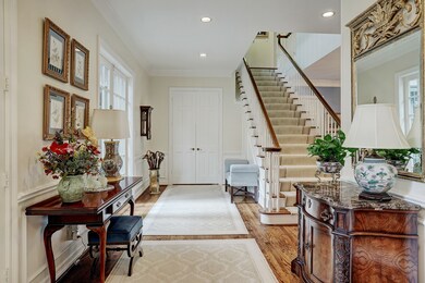 Stunning staircase anchors the entry way with bloc