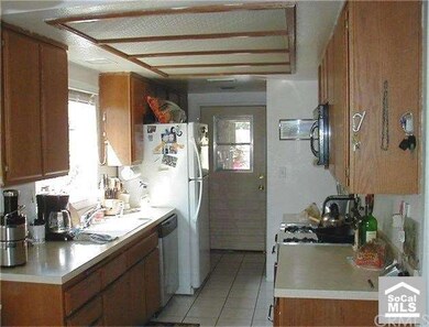Kitchen with lots of Wood Cabinets, Gas Stove, Dis