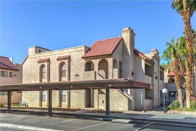 View of building exterior featuring covered parking