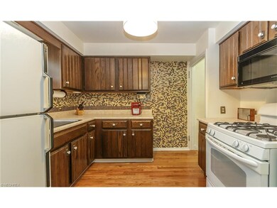 Kitchen features custom tile back splash and wood 