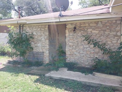 View of side of property with stone siding, brick