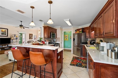 Kitchen featuring visible vents, a peninsula, a br