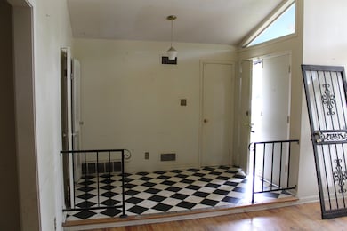 Foyer entrance featuring visible vents, lofted cei