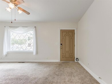 Unfurnished room featuring carpet and ceiling fan