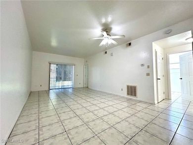 Empty room with light tile patterned floors, a hea