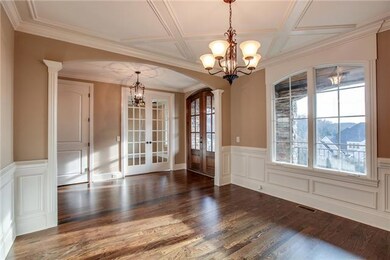 Hardwood and Ceramic Tile Floors throughout the Home. Formal Dining with beautifully detailed custom trimwork.