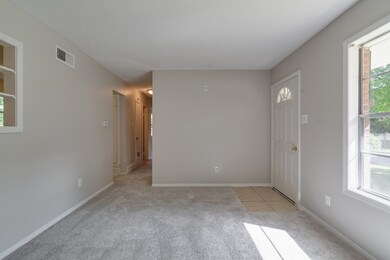 Newly carpeted Living Room with a healthy amount o