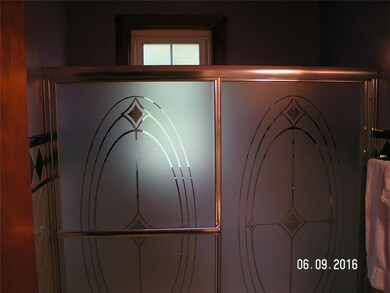 Updated bath with glass shower doors.