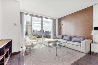 Living room with a city view, expansive windows, b