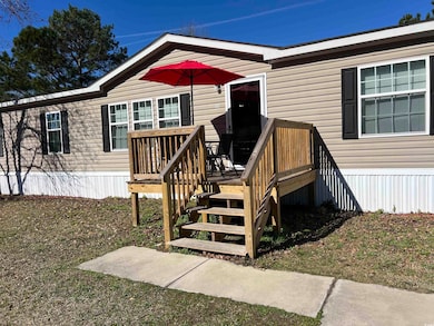 View of exterior entry featuring a lawn