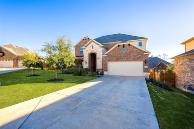 French provincial home featuring driveway, a garage, brick siding, and stone siding