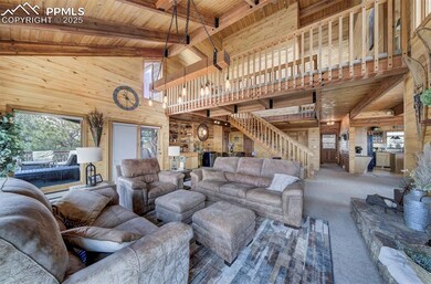 Living room with wood walls, high vaulted ceiling, wooden ceiling, carpet, and beam ceiling