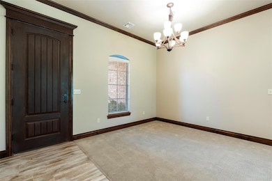 Unfurnished room featuring ornamental molding, a chandelier, and light wood-style flooring