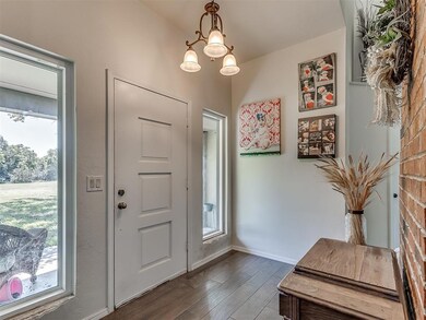 Entryway featuring a chandelier, a healthy amount 