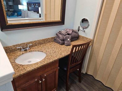 Full bath with vanity and wood finished floors