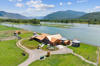 Birds eye view of property featuring Clarkfork River and mountain views