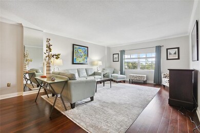 Living room is bright and airy, lots of natural li