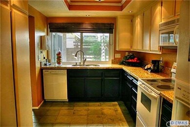 Kitchen with granite counters, white appliances, r