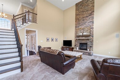 Family room w/beautiful floor-to-ceiling stone hea