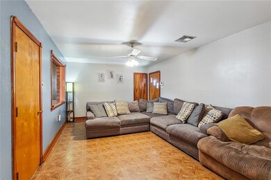 living room. door on left in picture leads to large flexible room space